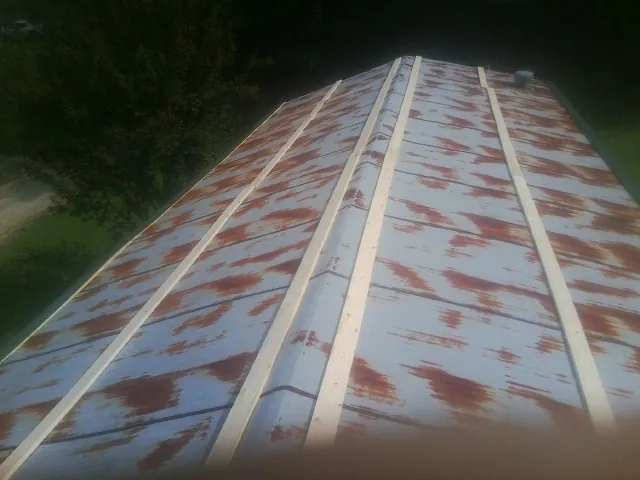 Rusted metal roof panels with new wood purlins before replacement — Storm Damage Roof Repair in Republic by Roofing Brothers